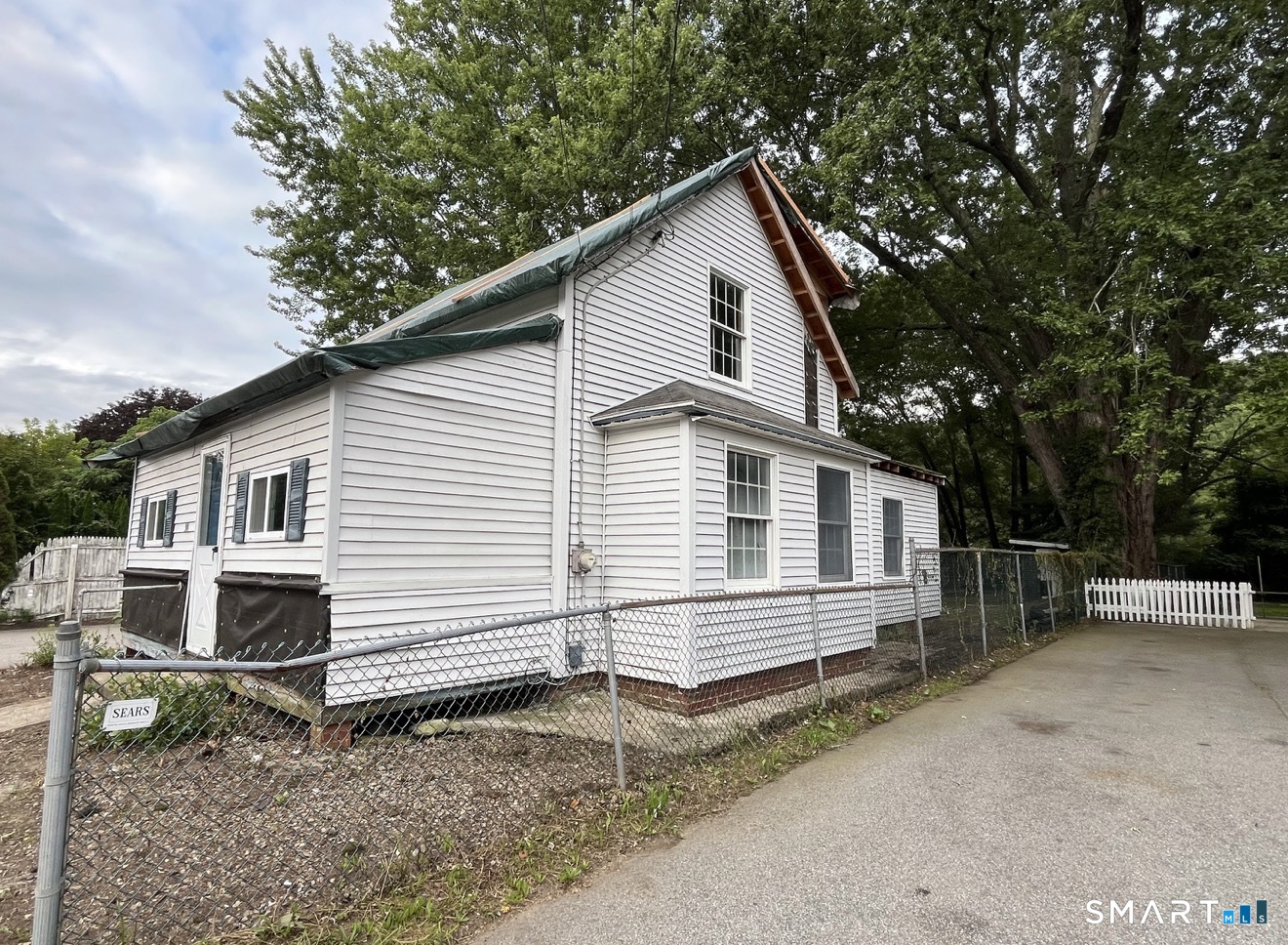 91 Taftville-Occum Road Norwich, CT 06360 - Photo 2 of 11 a view of a house with a yard and wooden fence