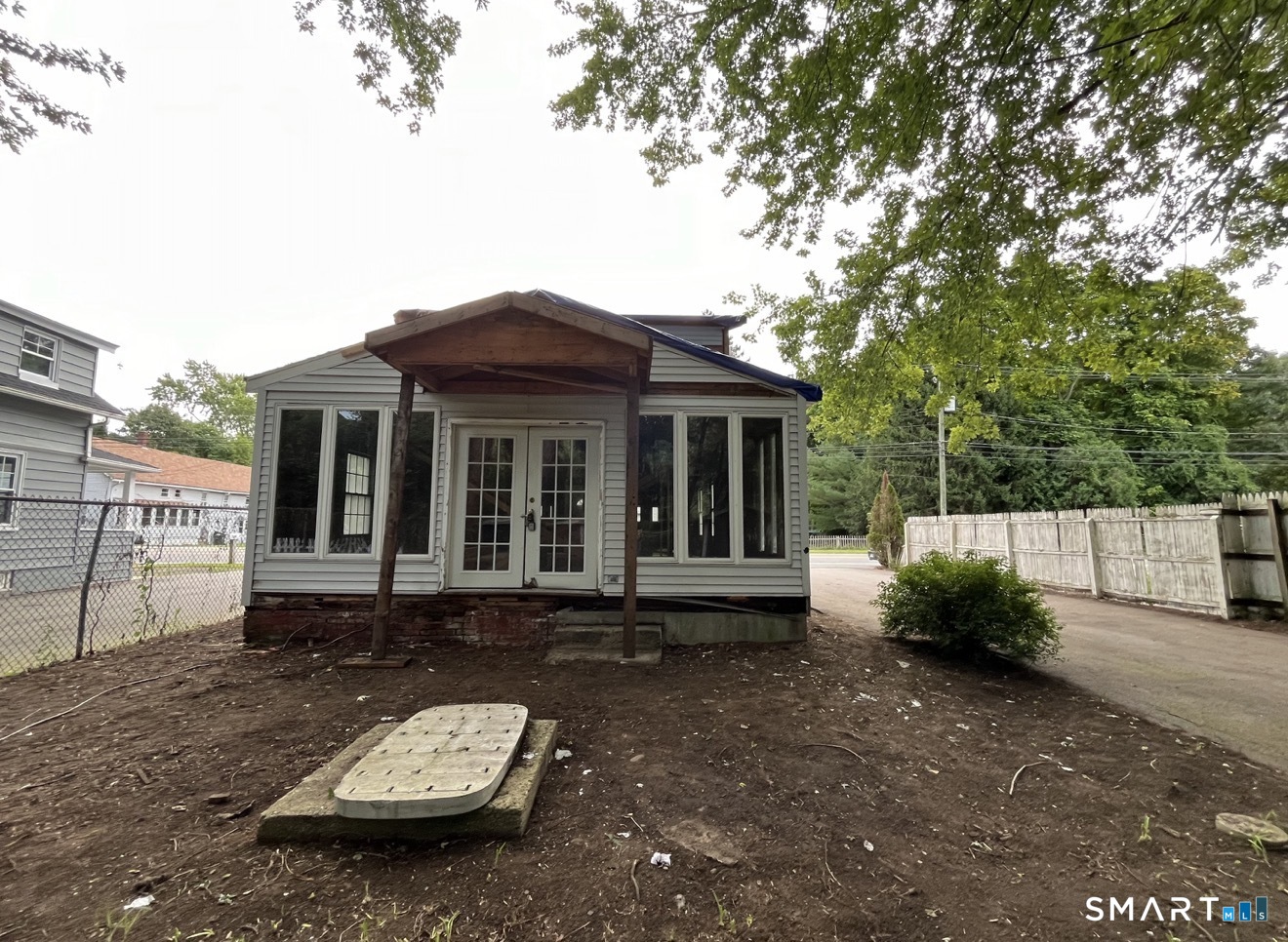 91 Taftville-Occum Road Norwich, CT 06360 - Photo 6 of 11 a backyard of a house with yard barbeque oven and outdoor seating