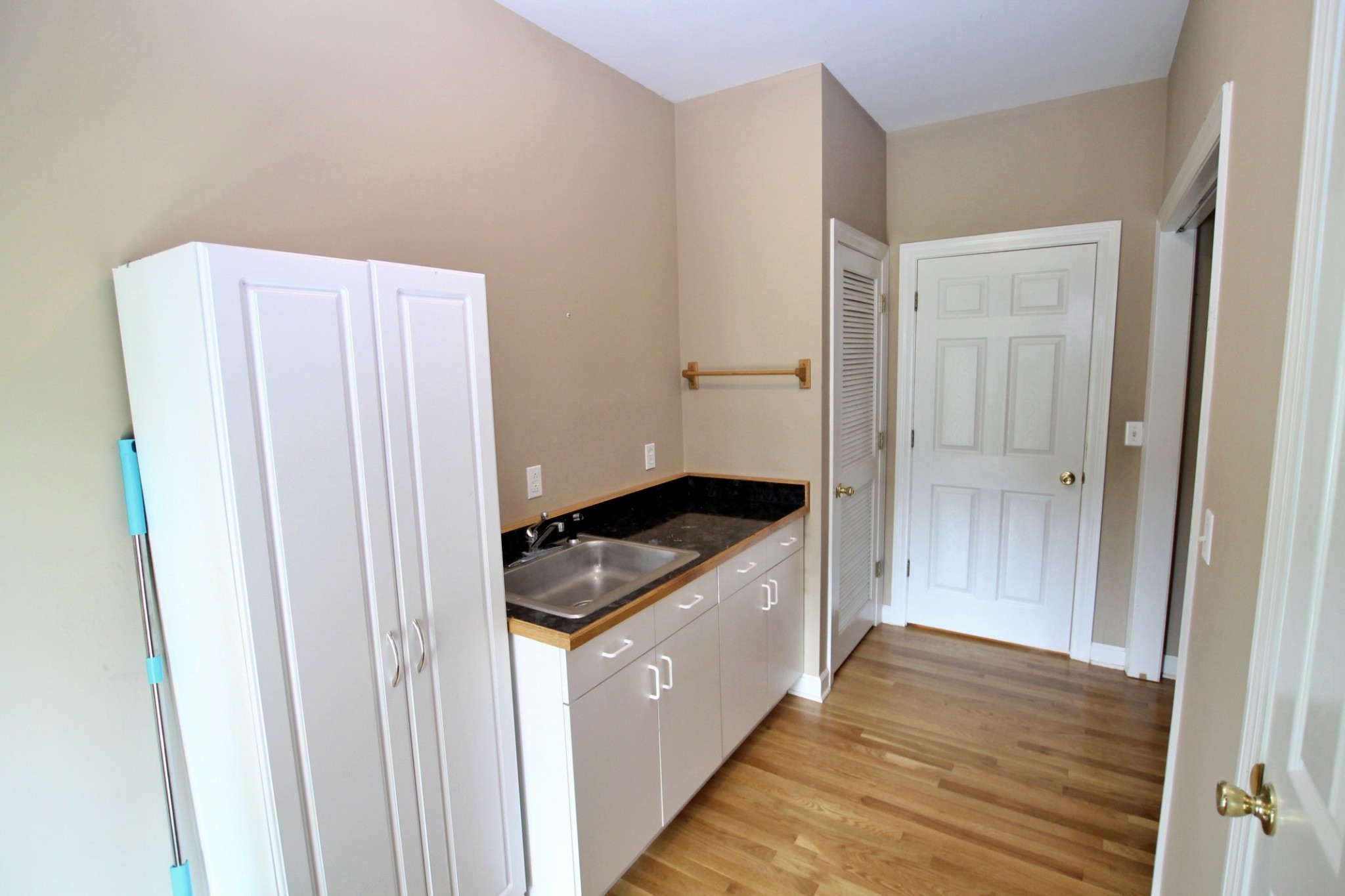 4181 Sandy Springs Road Springfield, TN 37172 - Photo 21 of 44 a kitchen with a wooden floor and white cabinets