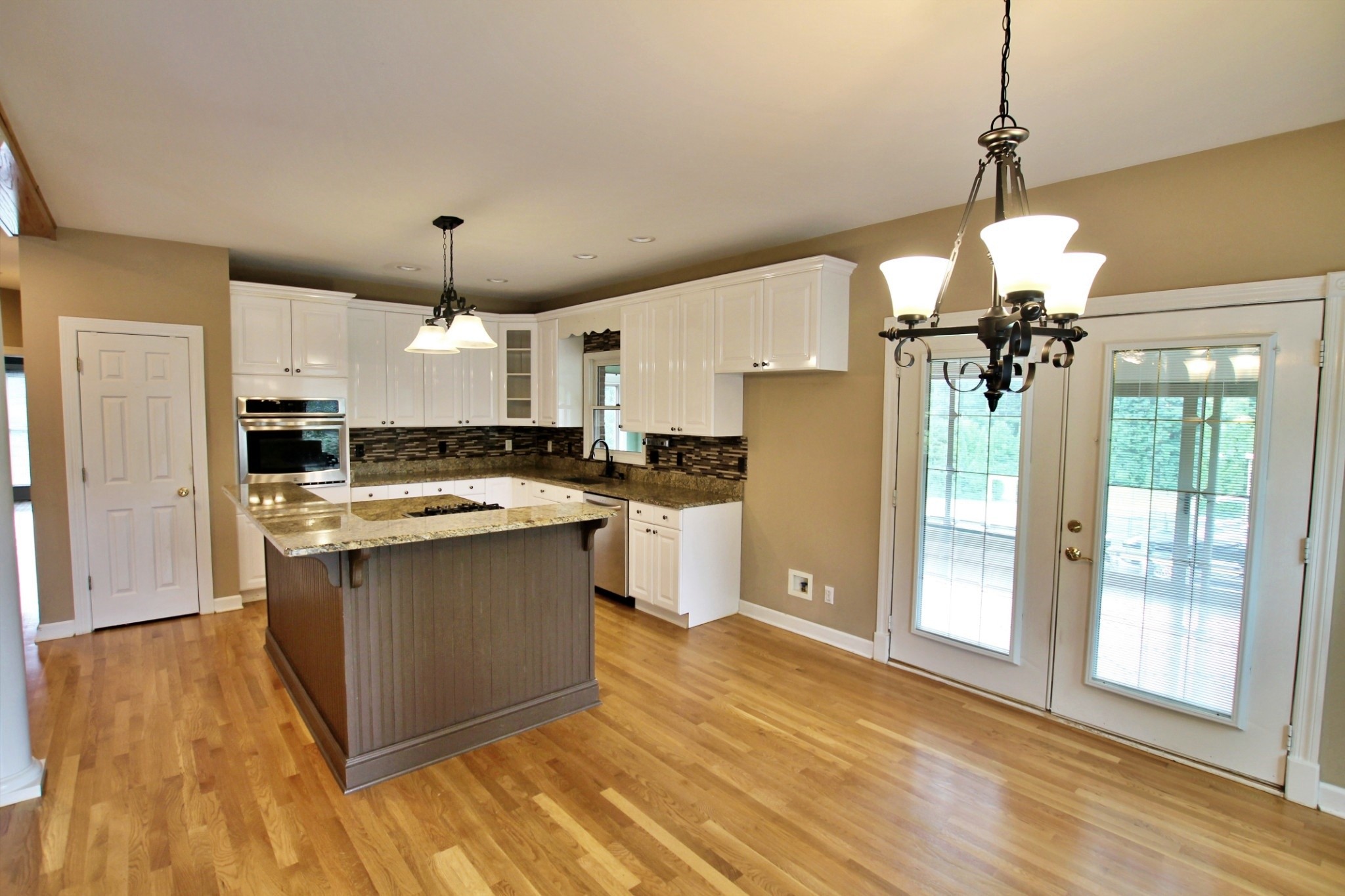 4181 Sandy Springs Road Springfield, TN 37172 - Photo 8 of 44 a kitchen with stainless steel appliances granite countertop a refrigerator a sink dishwasher a stove and white countertops with wooden floor