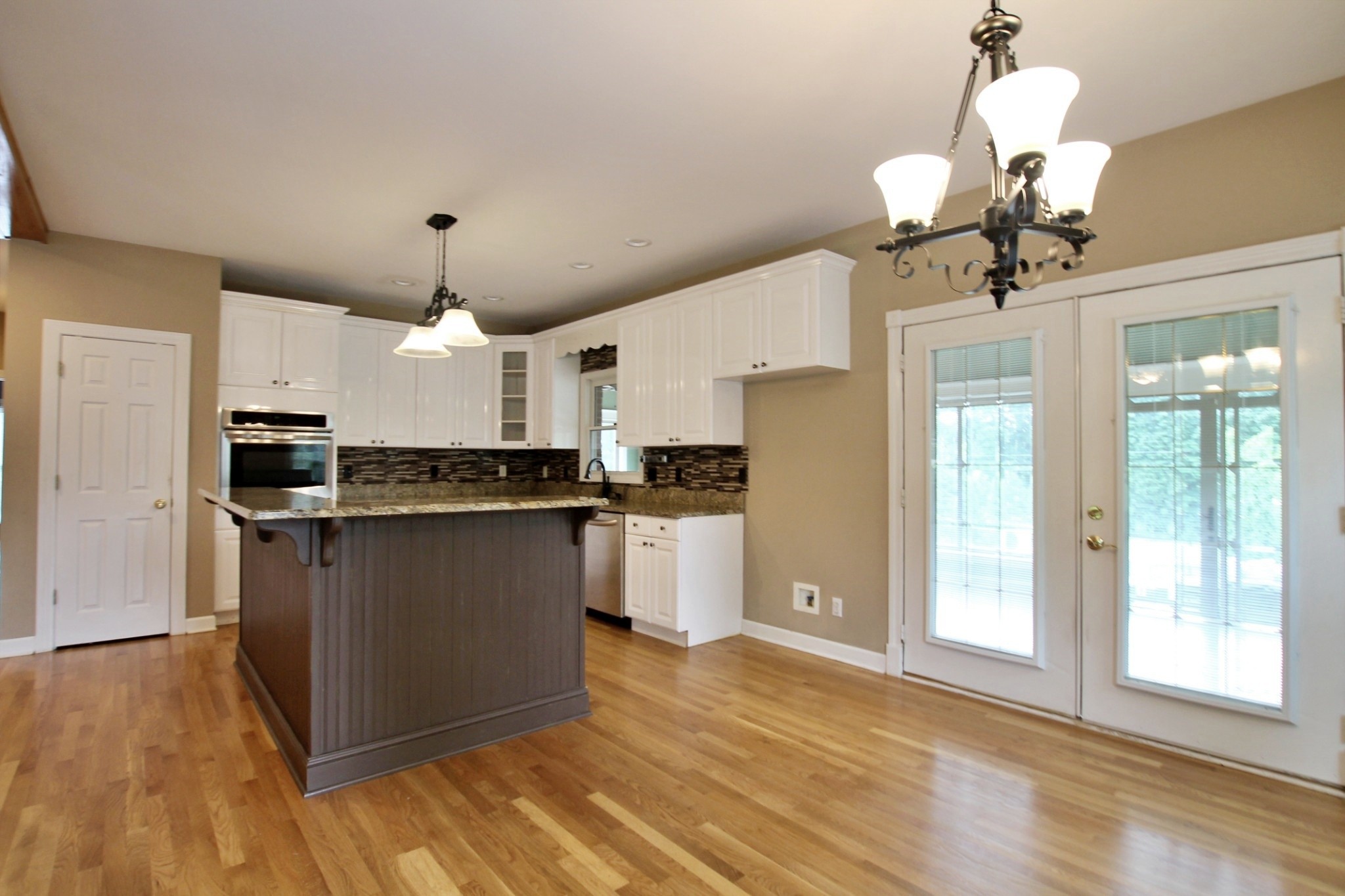 4181 Sandy Springs Road Springfield, TN 37172 - Photo 9 of 44 a kitchen with stainless steel appliances granite countertop a refrigerator a stove and a wooden floors