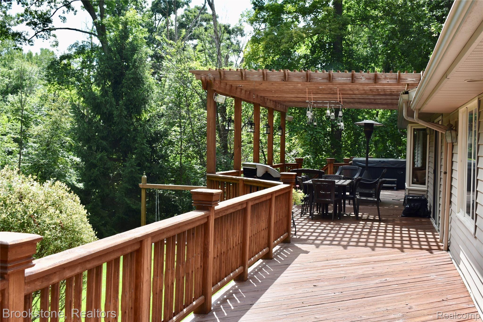 405 Baldwin Ridge Oxford, MI 48371 - Photo 13 of 54 THE LARGE WRAP-AROUND DECK STARTS OUTSIDE THE LARGE MASTER BEDROOM SUITE (15X20) AND LEADS TO THE LARGE PERGOLA (16X28)