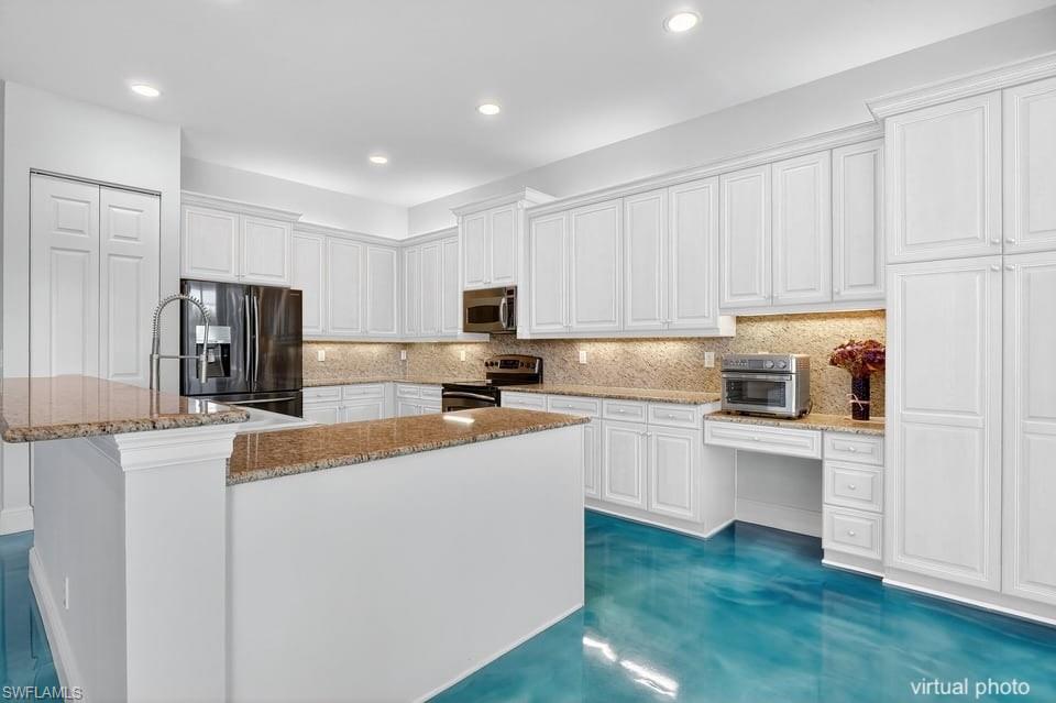 2234 Campestre Terrace Naples, FL 34119 - Photo 15 of 48 Kitchen with white cabinets, decorative backsplash, stainless steel appliances, light stone countertops, and recessed lighting