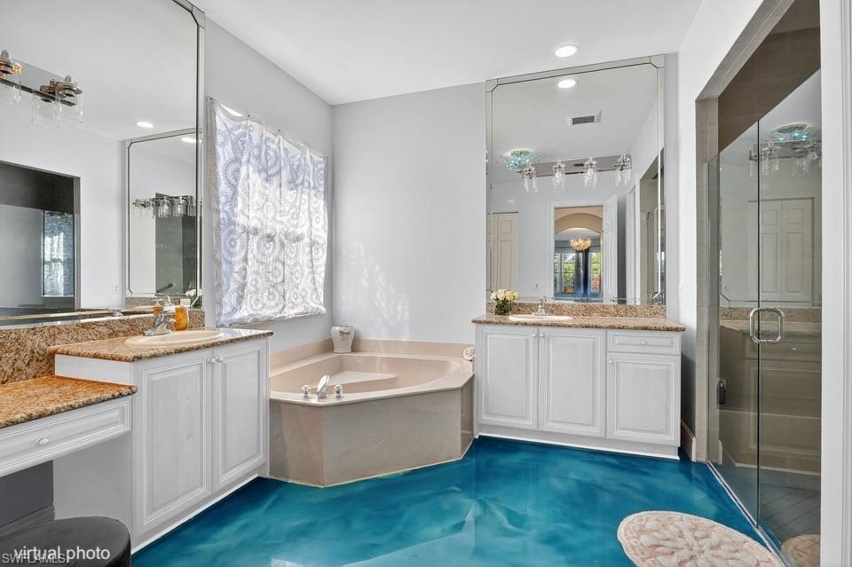 2234 Campestre Terrace Naples, FL 34119 - Photo 19 of 48 Full bathroom featuring a stall shower, two vanities, a bath, healthy amount of natural light, and recessed lighting