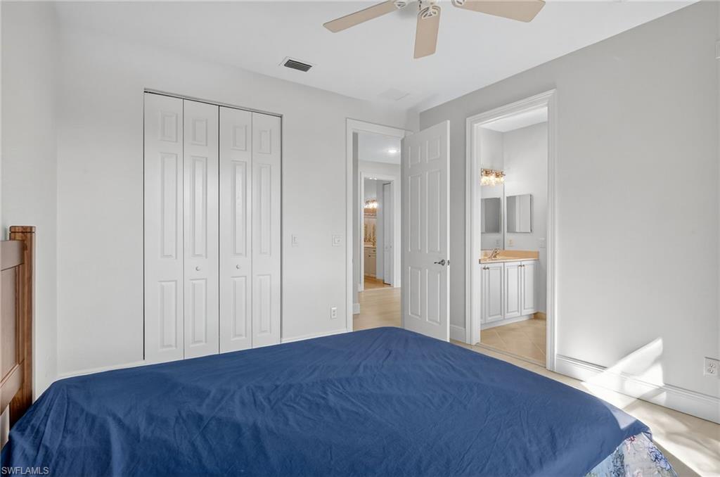 2234 Campestre Terrace Naples, FL 34119 - Photo 35 of 48 Bedroom featuring a ceiling fan and a closet