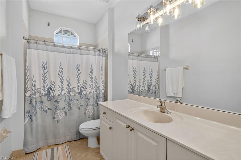 2234 Campestre Terrace Naples, FL 34119 - Photo 37 of 48 Bathroom with vanity, light tile patterned flooring, and a shower with curtain
