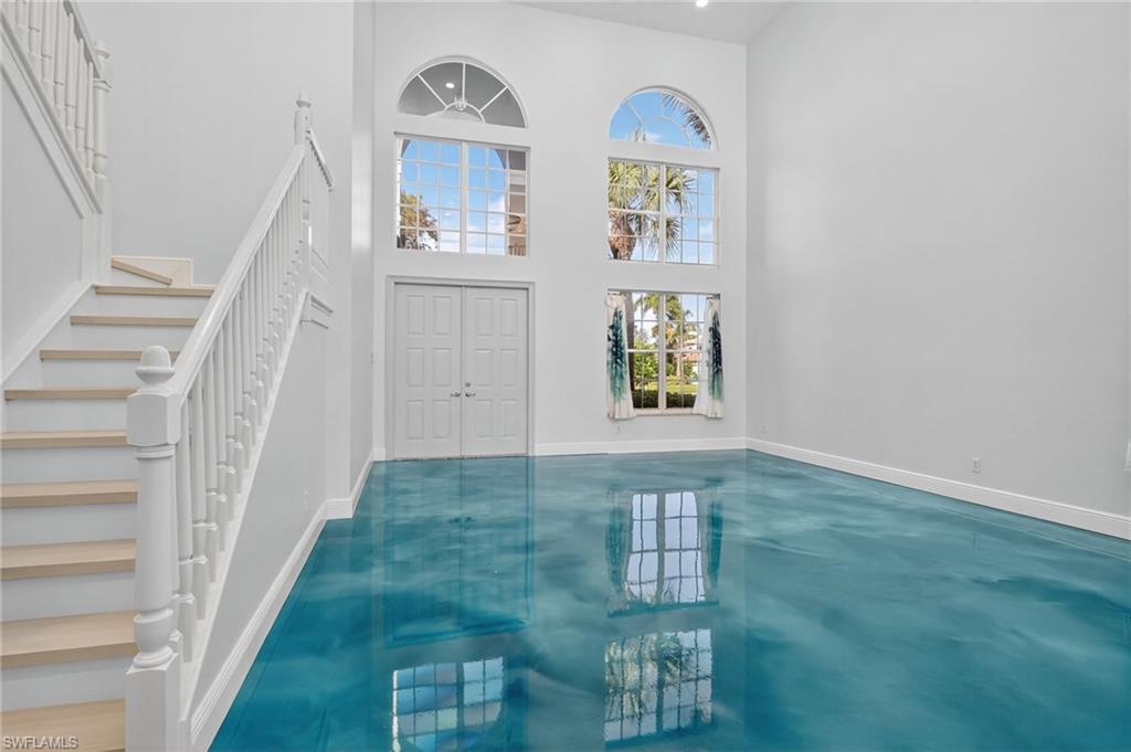 2234 Campestre Terrace Naples, FL 34119 - Photo 7 of 48 Entrance foyer featuring stairway, concrete flooring, and a high ceiling