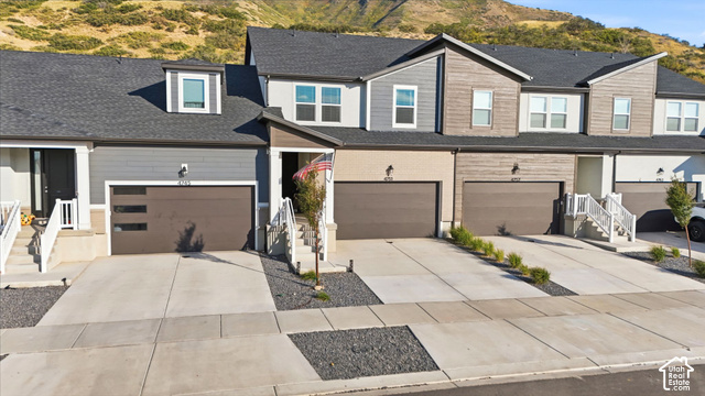4751 Heartwood Road Mapleton, UT 84664 - Photo 2 of 33 Townhome exterior featuring varied siding materials, attached garages, and a paved driveway