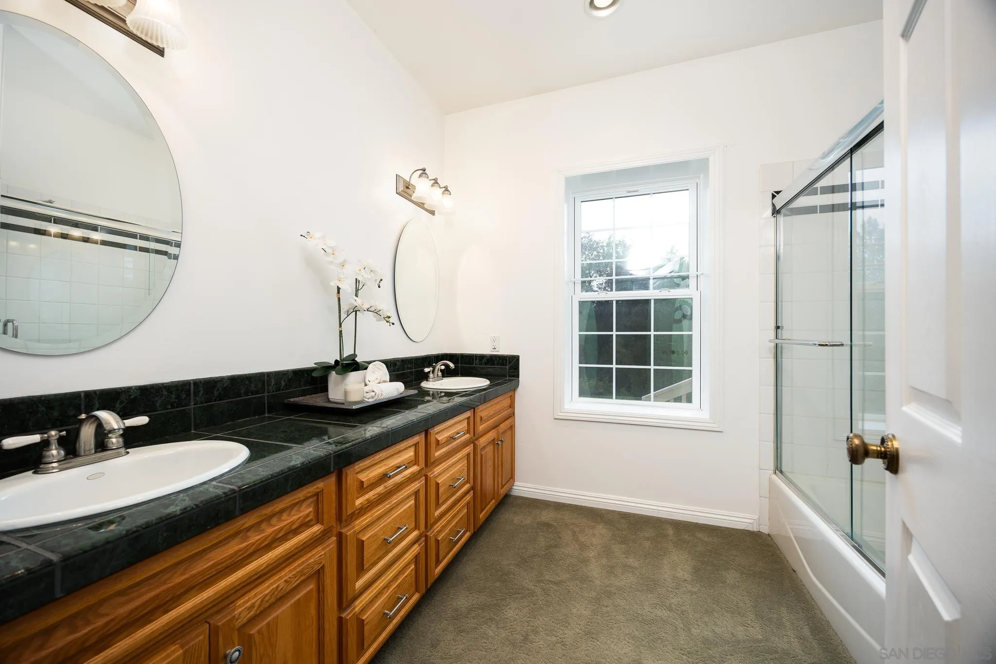 7570 Corte Madera Road Pine Valley, CA 91962 - Photo 21 of 53 a bathroom with a granite countertop sink a mirror a vanity and a shower