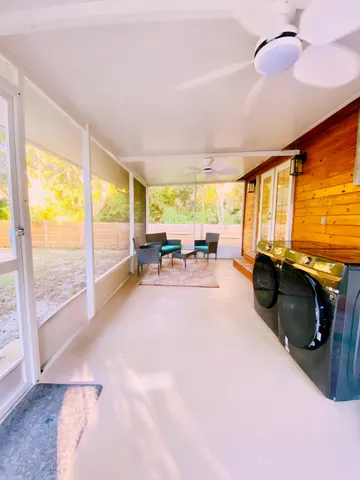 a view of a swimming pool with a patio and a yard