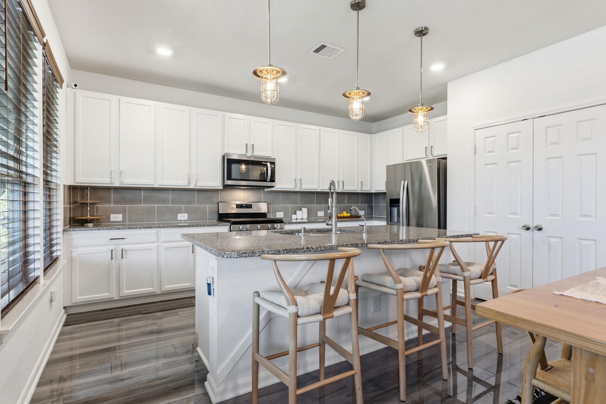 5127 Avondale Rise Street Katy, TX 77493 - Photo 15 of 47 a kitchen with stainless steel appliances kitchen island granite countertop a wooden cabinets and a stove top oven