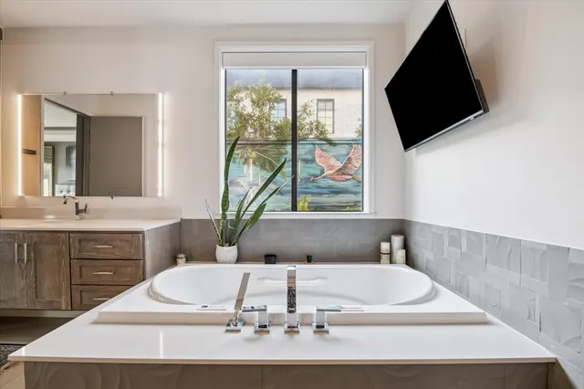 a bath tub sitting in a bathroom and a sink