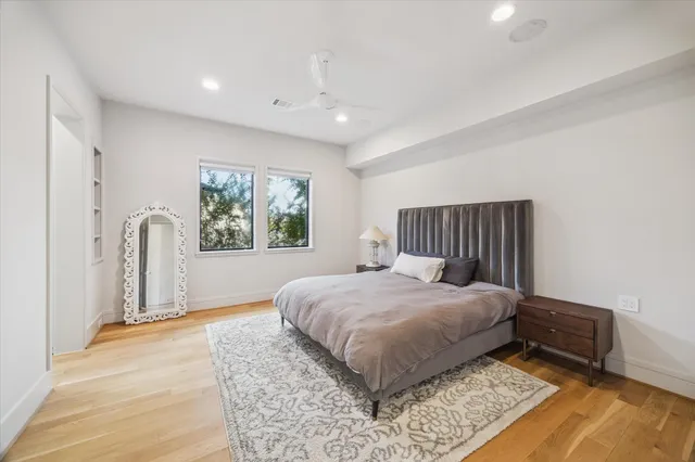 a spacious bedroom with a bed and a window