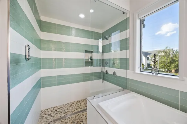 a bathroom with a tub and a shower