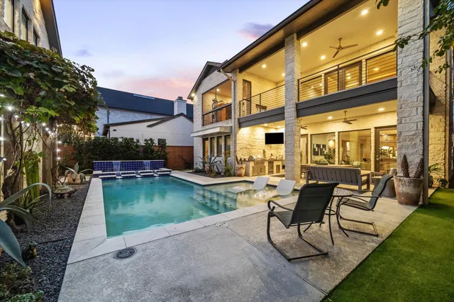 a view of a house with backyard sitting area and garden