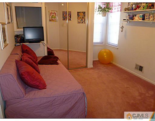 116 Almond Road Freehold, NJ 07728 - Photo 7 of 14 a bedroom with a bed and a flat screen tv