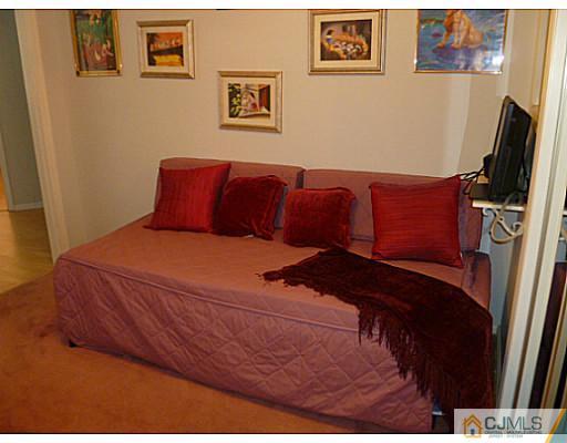 116 Almond Road Freehold, NJ 07728 - Photo 8 of 14 a bedroom with a bed and a flat screen tv