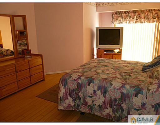 116 Almond Road Freehold, NJ 07728 - Photo 10 of 14 a bedroom with a bed and a flat screen tv