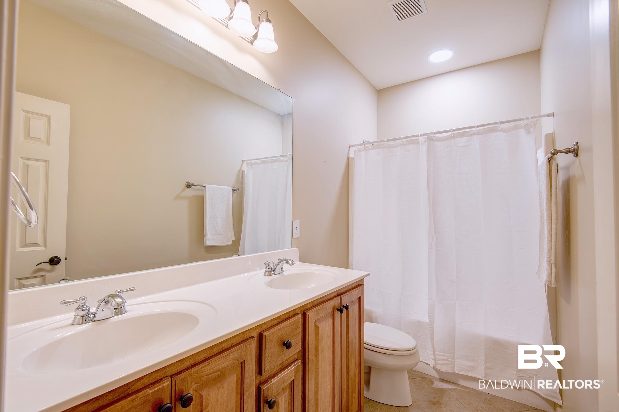 9421 Collier Loop Daphne, AL 36526 - Photo 18 of 31 Bathroom with double vanity, shower / bath combo, light tile patterned floors, and recessed lighting