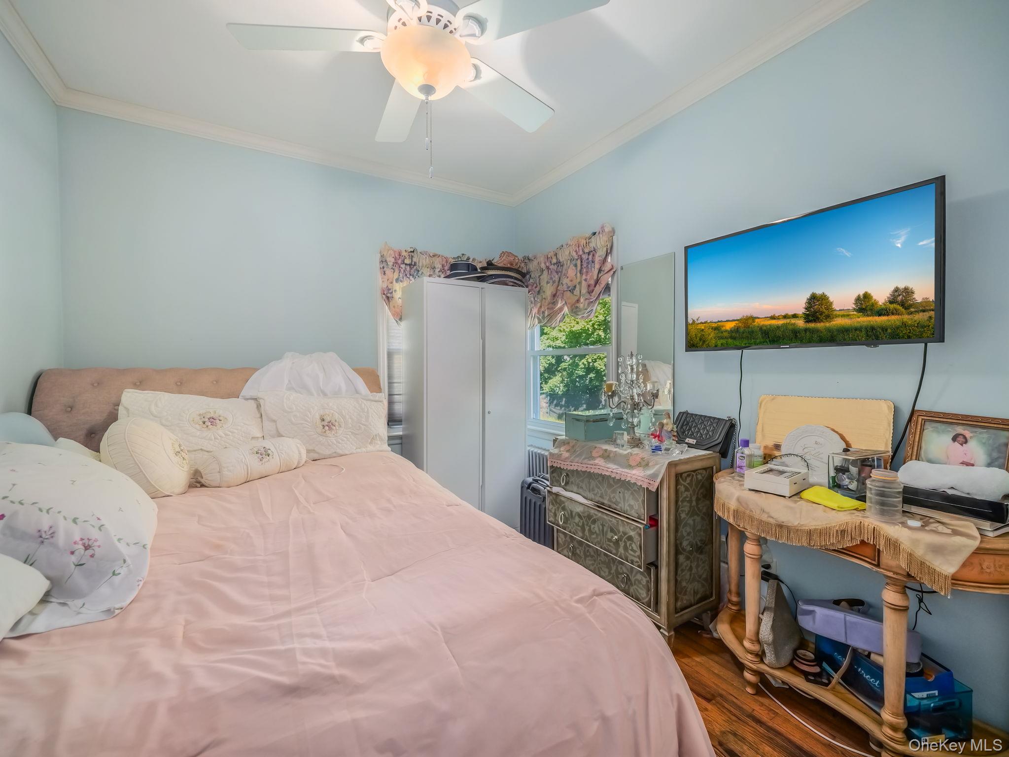3 South Myrtle Avenue Spring Valley, NY 10977 - Photo 15 of 40 Bedroom with ornamental molding, wood finished floors, and a ceiling fan