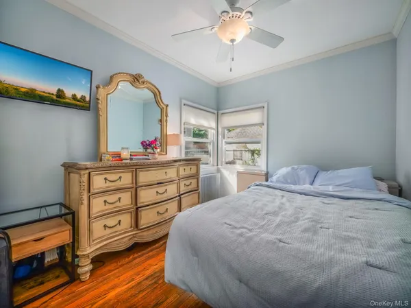 a bedroom with a bed and a dresser in it