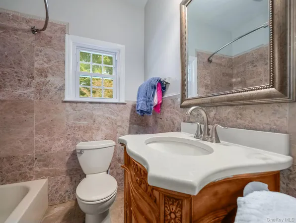 a kitchen with stainless steel appliances granite countertop a stove top oven a refrigerator a sink and chairs