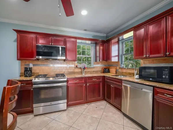a kitchen with stainless steel appliances granite countertop a stove top oven a sink and dishwasher