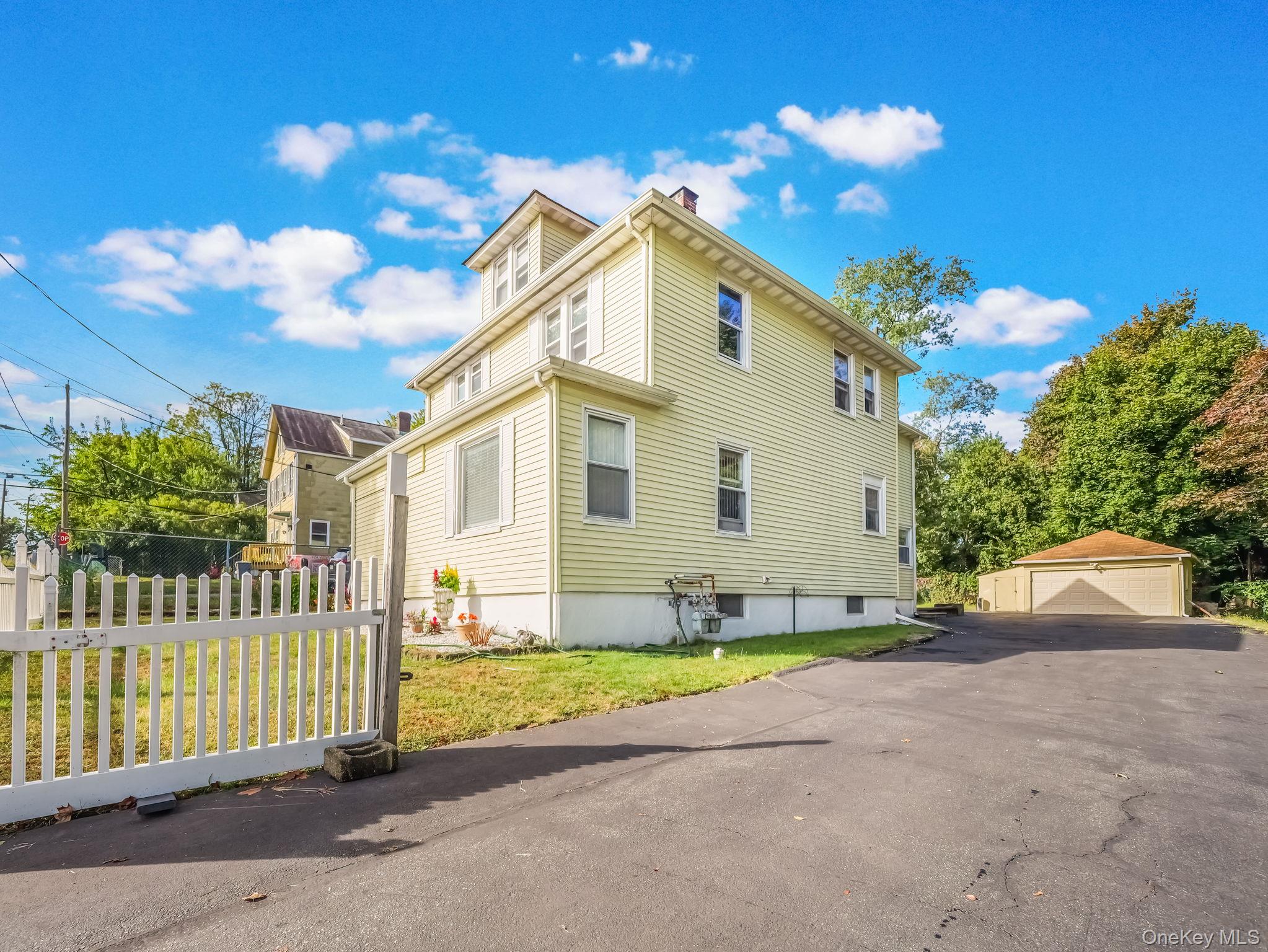 3 South Myrtle Avenue Spring Valley, NY 10977 - Photo 2 of 40 View of side of property featuring an outbuilding, a garage, a yard, and a chimney