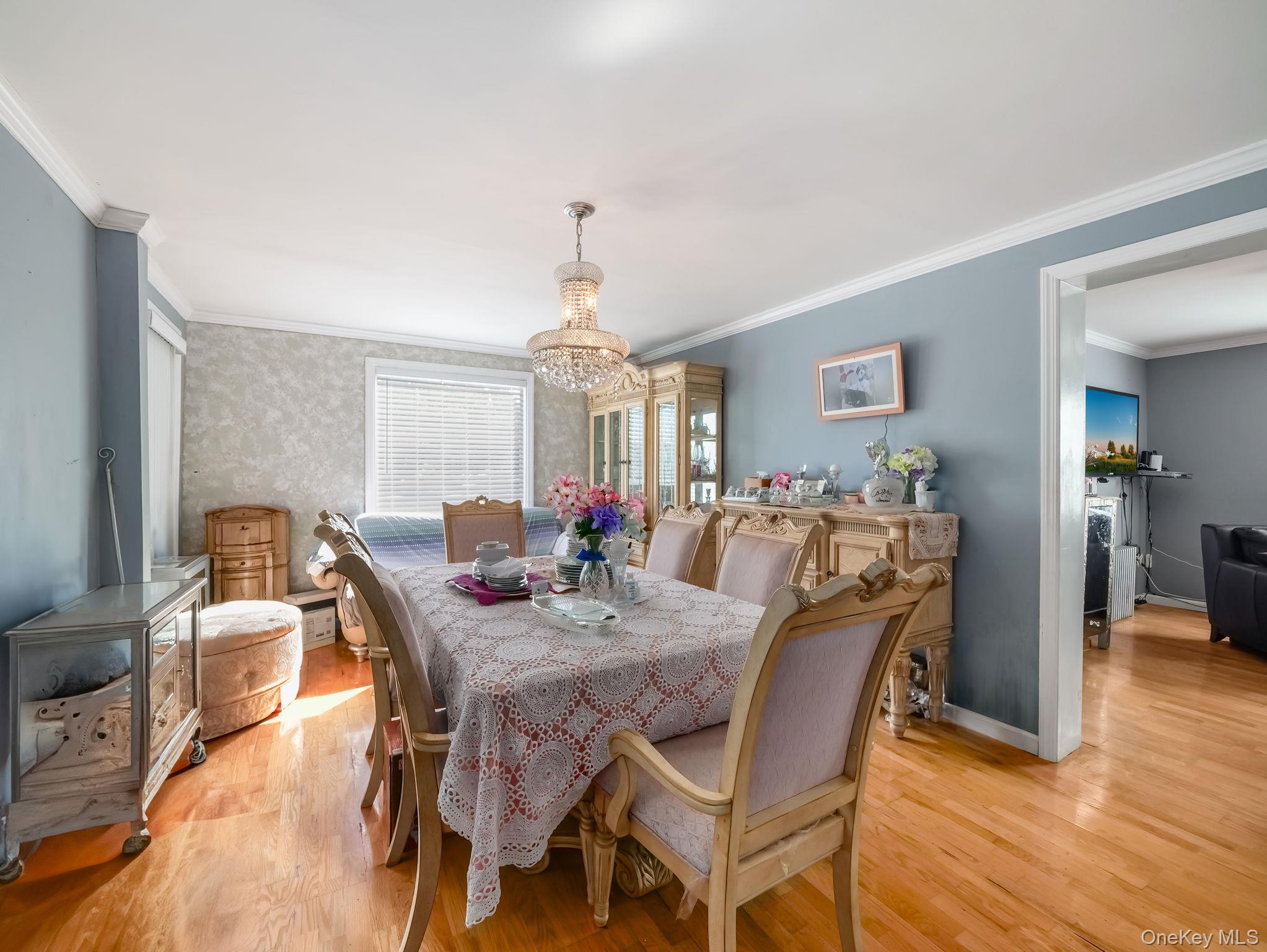 3 South Myrtle Avenue Spring Valley, NY 10977 - Photo 24 of 40 Dining area with ornamental molding, wood finished floors, and a chandelier