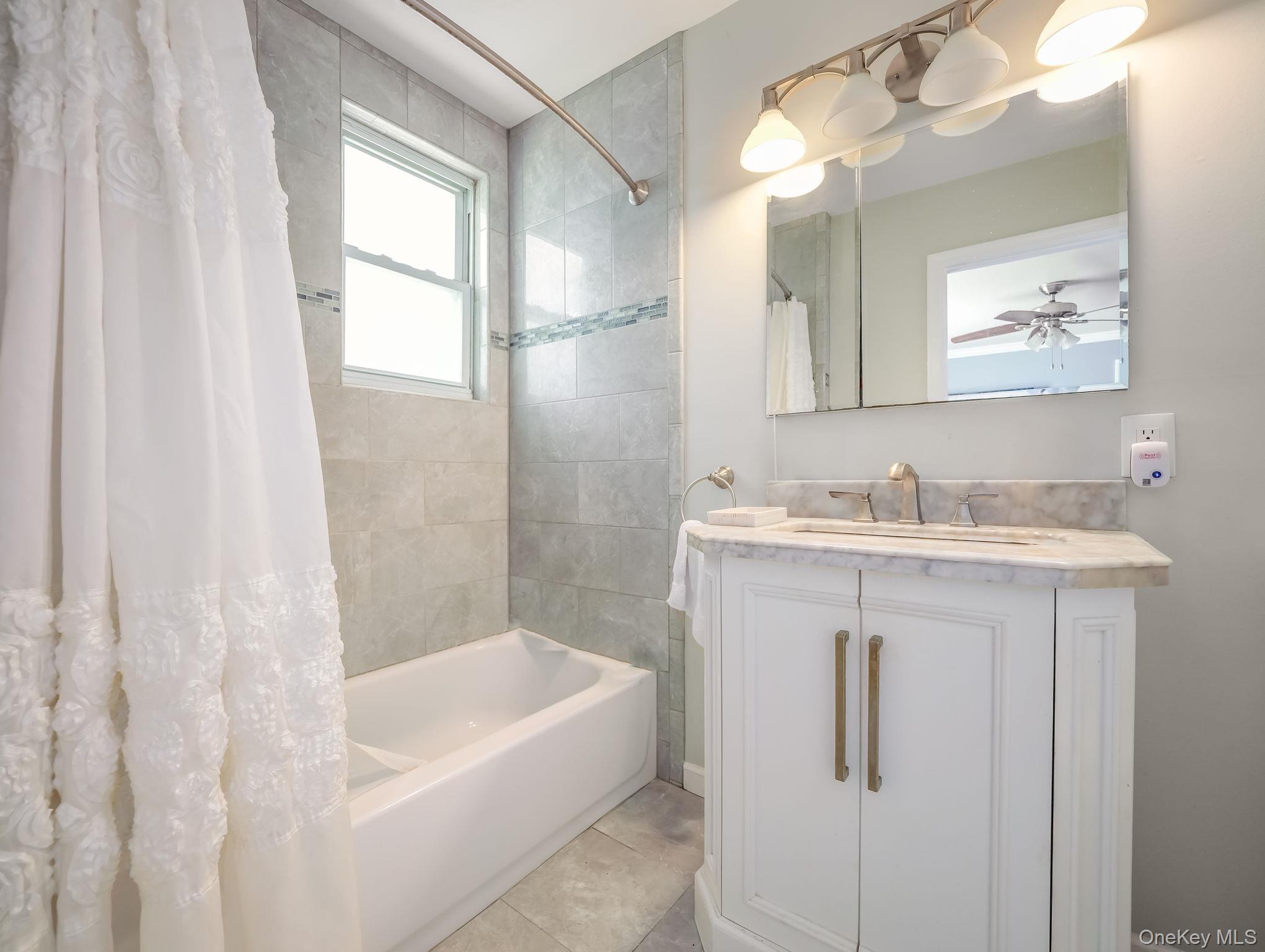 3 South Myrtle Avenue Spring Valley, NY 10977 - Photo 27 of 40 Bathroom with shower / bath combo, vanity, light tile patterned flooring, and ceiling fan
