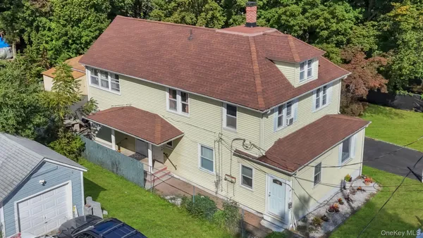 a aerial view of a house with a yard
