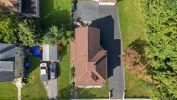 a backyard of a house with plants and trees