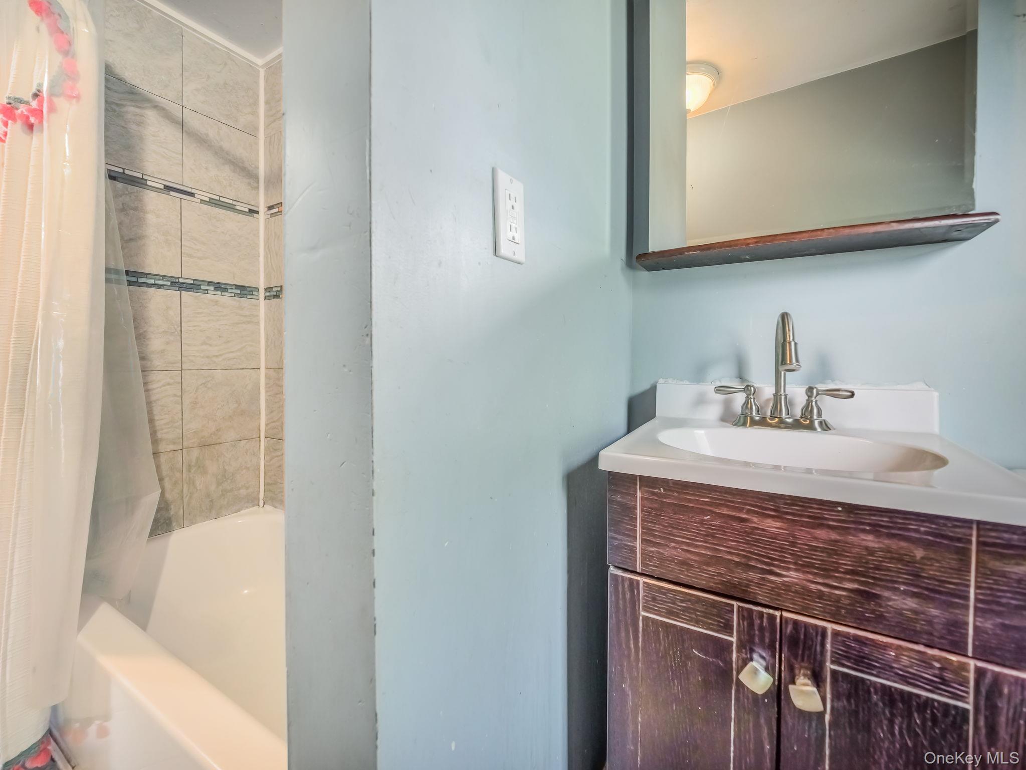 3 South Myrtle Avenue Spring Valley, NY 10977 - Photo 8 of 40 Full bathroom with shower / tub combo with curtain and vanity