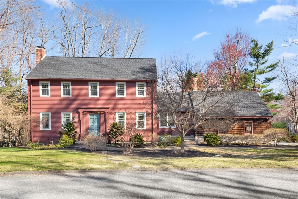 a view of a house with a yard in front of it