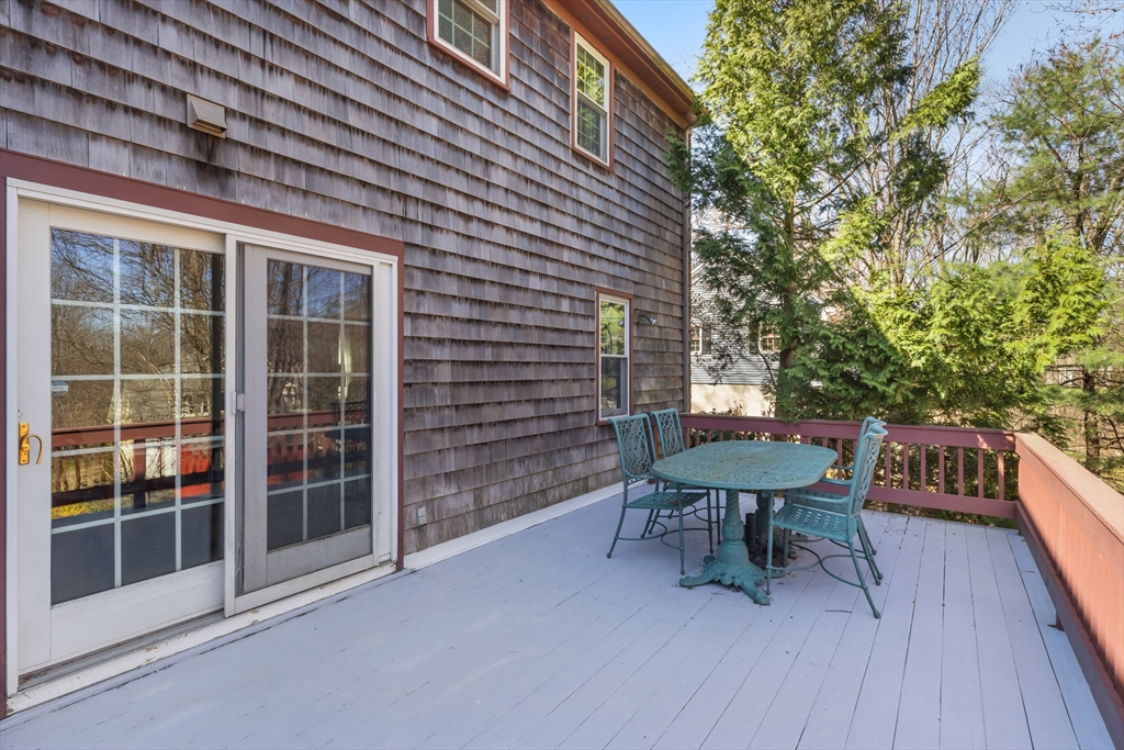 77 Forest Drive Holden, MA 01520 - Photo 26 of 27 a view of a patio with table and chairs with wooden floor and fence