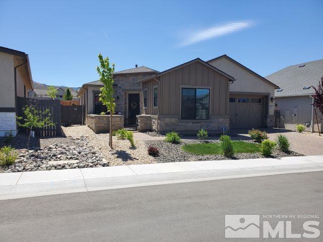 2522 Titanium Crest Drive Reno, NV 89521 - Photo 1 of 23 a front view of a house with a yard and potted plants