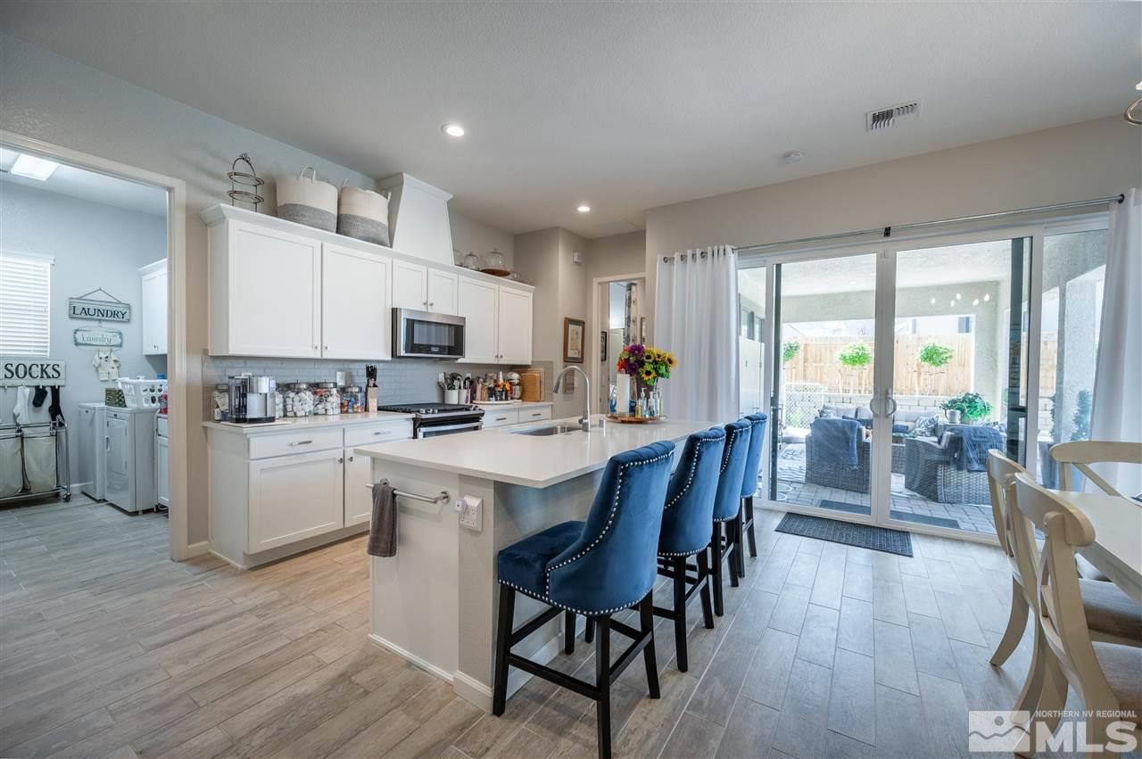 2522 Titanium Crest Drive Reno, NV 89521 - Photo 5 of 23 a kitchen with microwave a sink and chairs