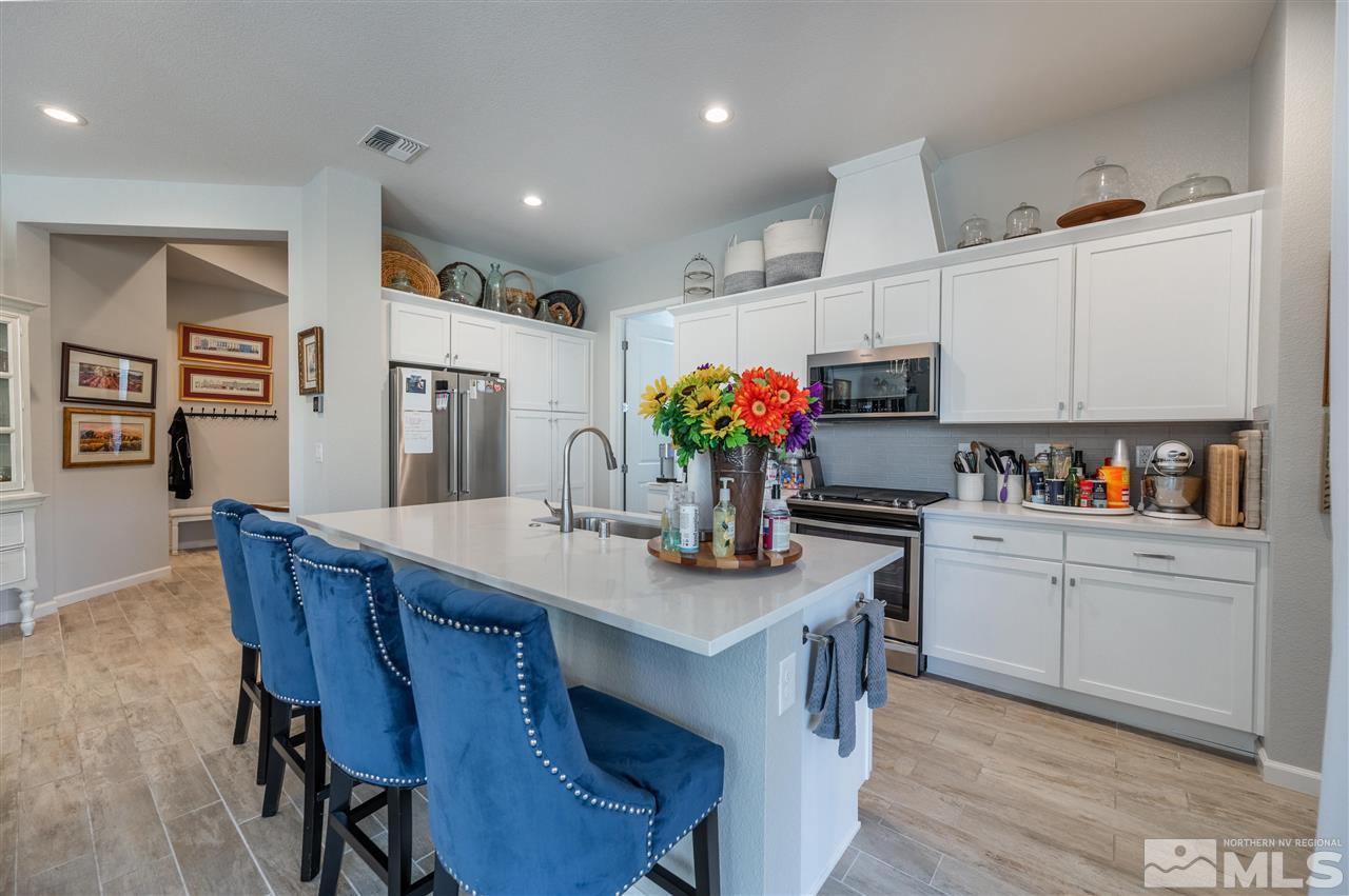 2522 Titanium Crest Drive Reno, NV 89521 - Photo 6 of 23 a kitchen with granite countertop white cabinets and refrigerator