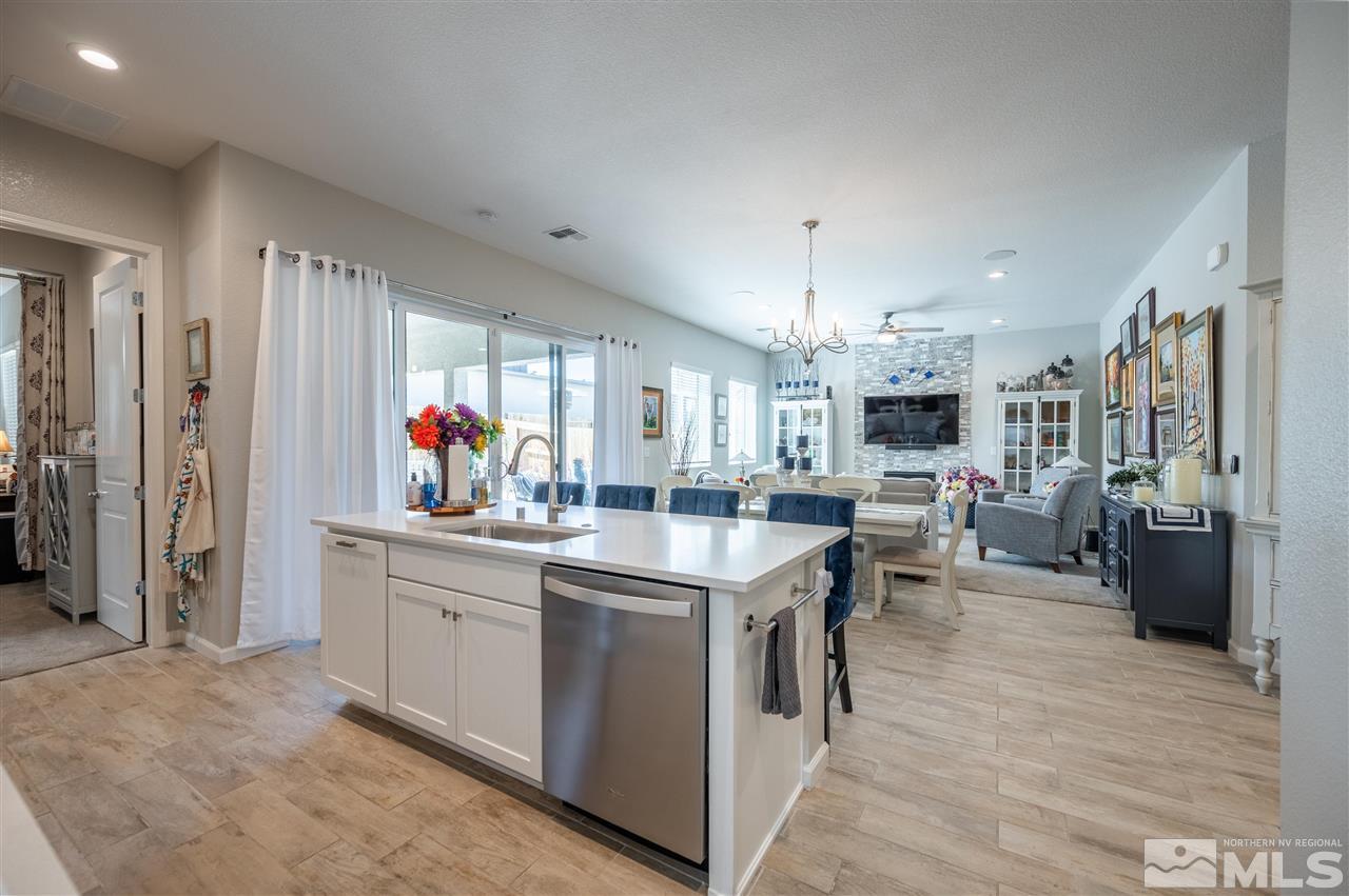 2522 Titanium Crest Drive Reno, NV 89521 - Photo 7 of 23 a kitchen that has a lot of white cabinets and stainless steel appliances