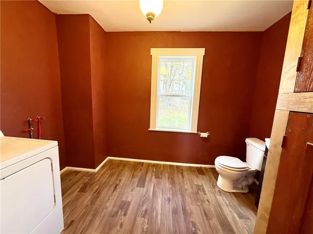 a bathroom with a toilet and a window