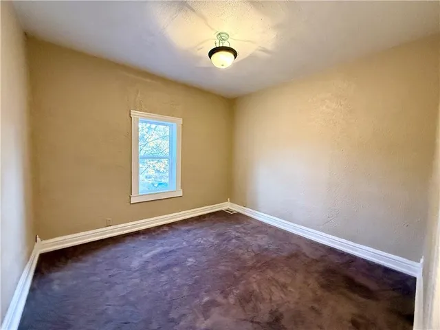 an empty room with windows and window