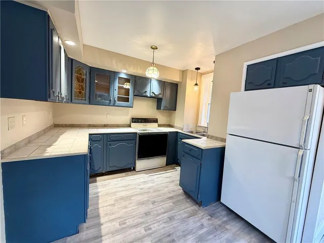 a kitchen with a refrigerator a sink and a microwave