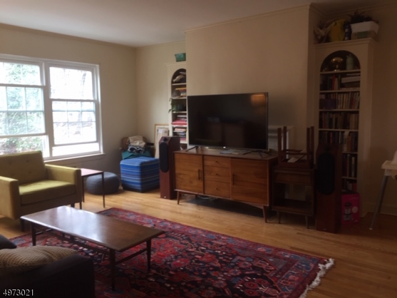 33 Hillside Avenue, Unit 2 Montclair, NJ 07042 - Photo 2 of 8 a living room with furniture and a flat screen tv