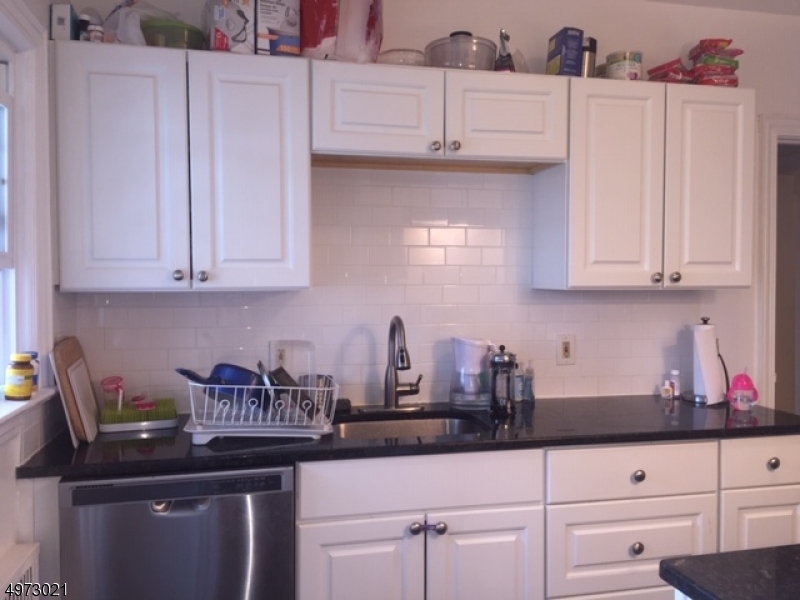 33 Hillside Avenue, Unit 2 Montclair, NJ 07042 - Photo 4 of 8 a kitchen with granite countertop white cabinets and a stove