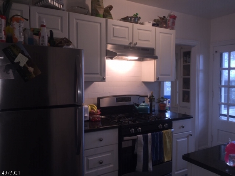33 Hillside Avenue, Unit 2 Montclair, NJ 07042 - Photo 5 of 8 a kitchen with refrigerator and window