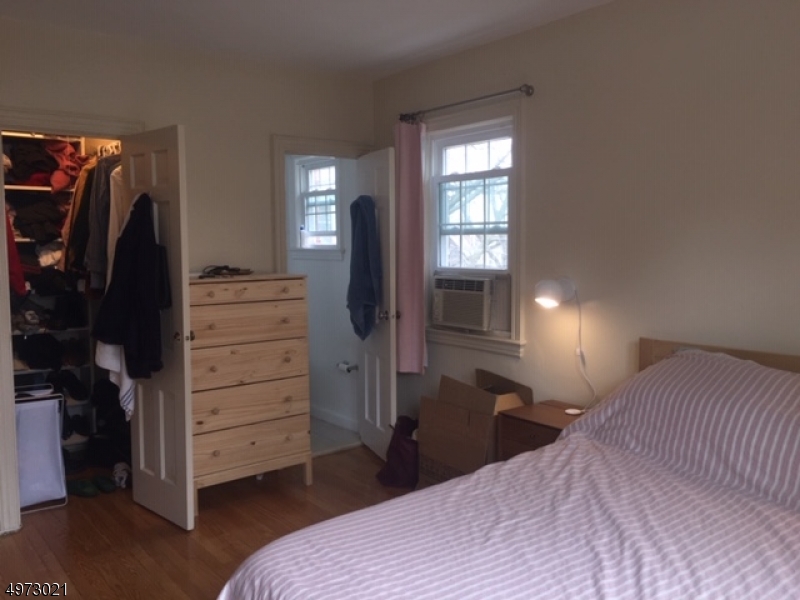 33 Hillside Avenue, Unit 2 Montclair, NJ 07042 - Photo 7 of 8 a bedroom with a bed and a television