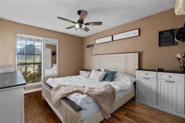 a bedroom with a large bed and a chandelier