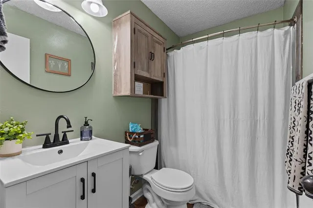 a living room with hard wood floors and a window