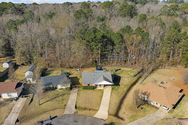 an aerial view of a house with a yard
