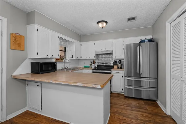 a kitchen with a refrigerator and a sink